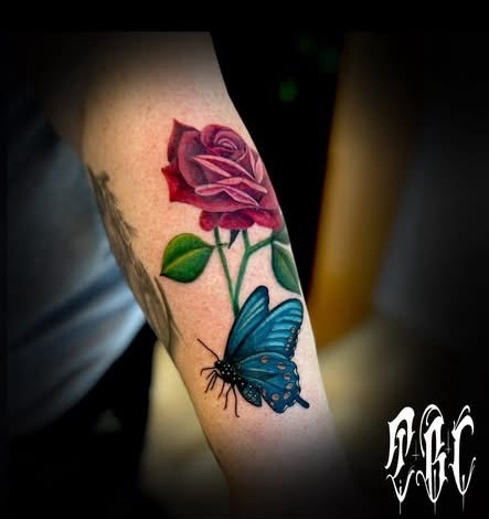 Color realism rose and blue butterfly forearm tattoo by Clayton